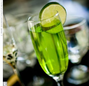 This green cocktail drink served in a champagne flute adds a fun touch to any party.