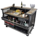 Distressed Bar Cart Stocked With Liquors And Serving Glasses